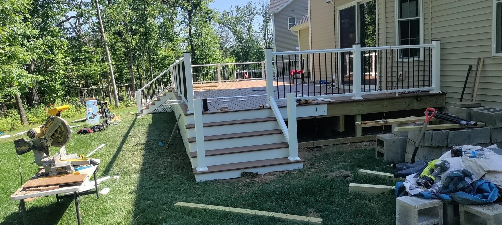 Completed deck with white railings and lattice