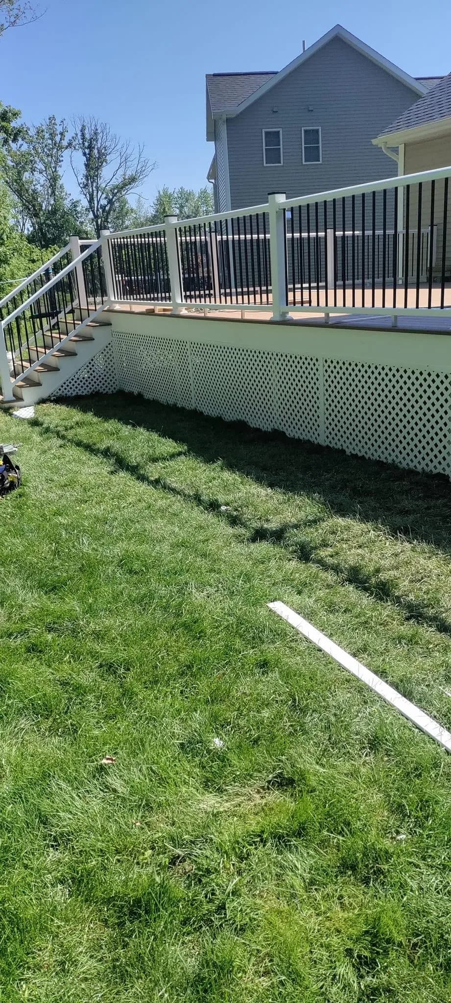 Low-profile deck side view with white lattice skirt