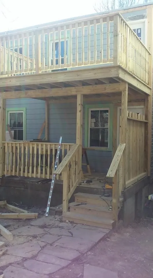 Two-story porch under construction with wooden framing