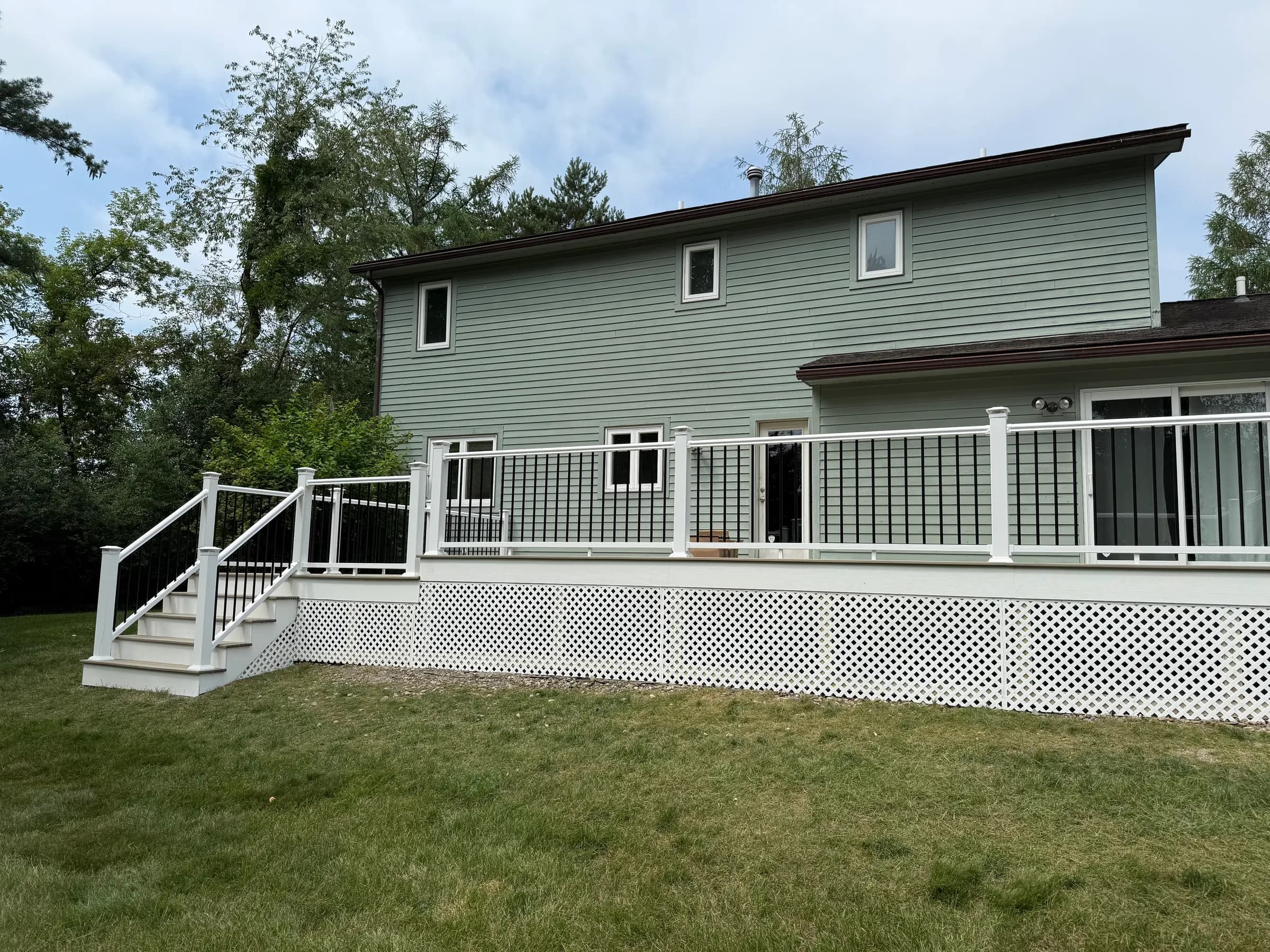 Composite deck stairs with white lattice skirt