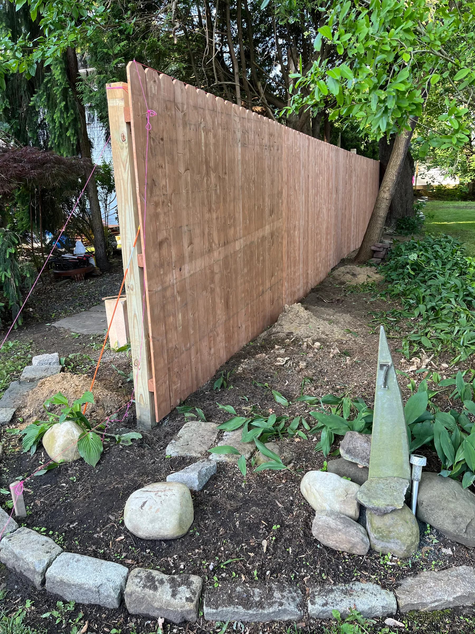 Winding wooden walkway through garden landscape