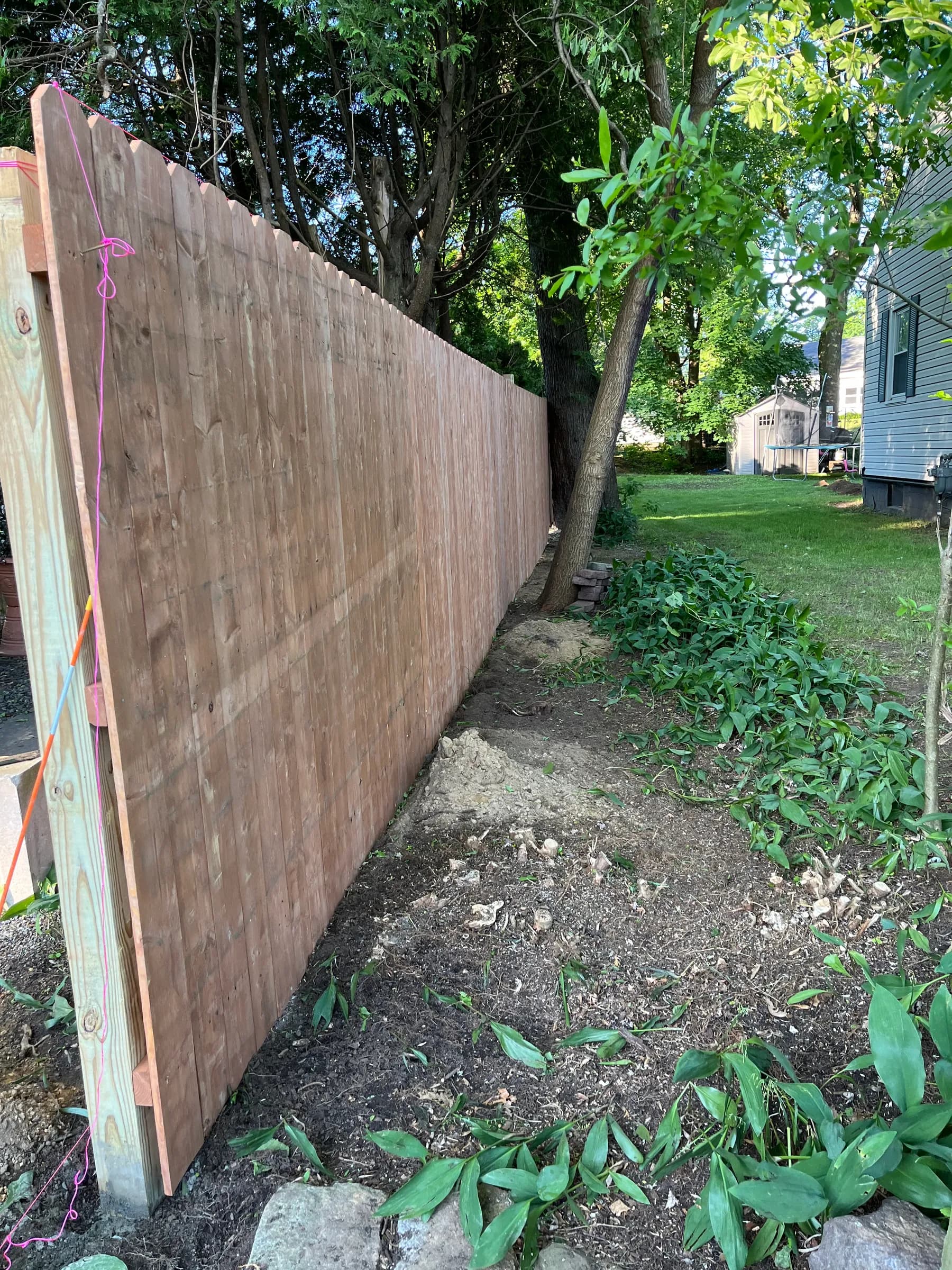 Wooden walkway extending across backyard