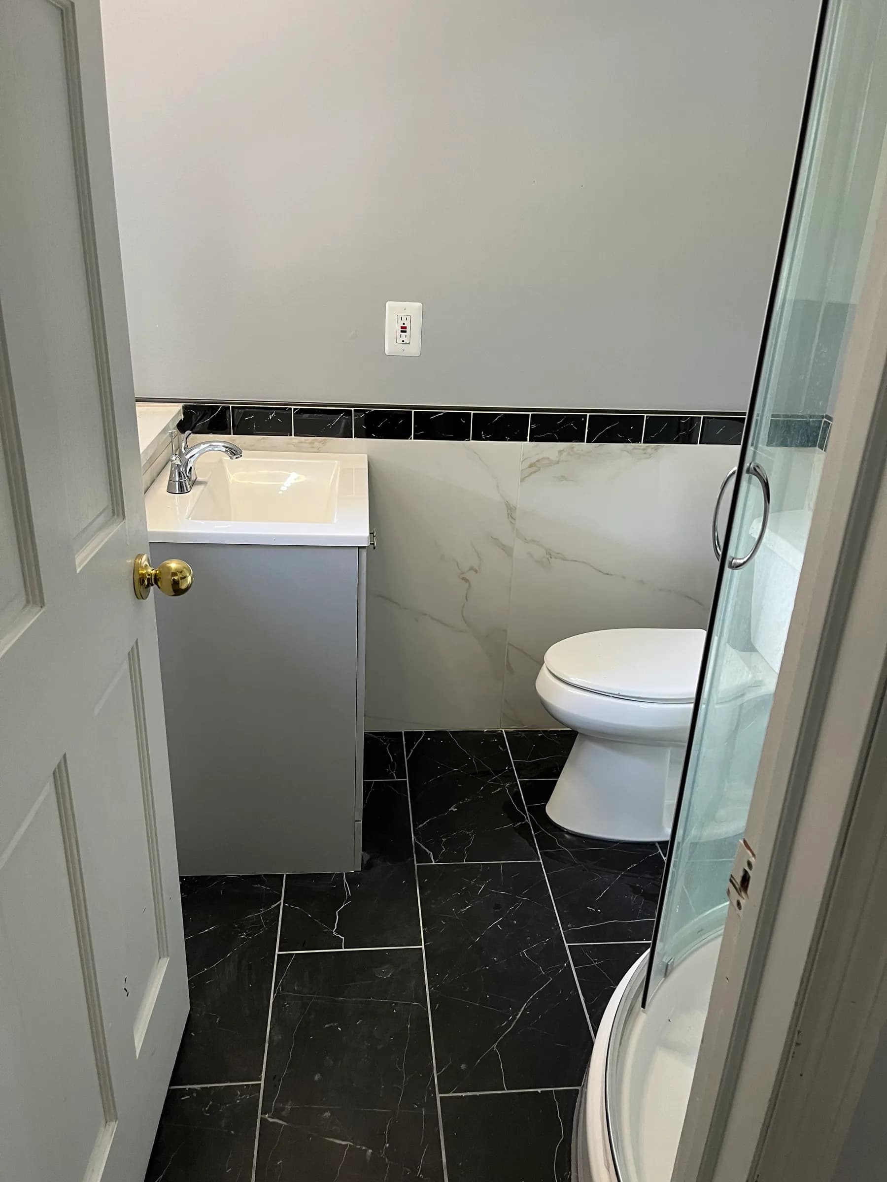 Luxury bathroom with black marble walls and modern vanity