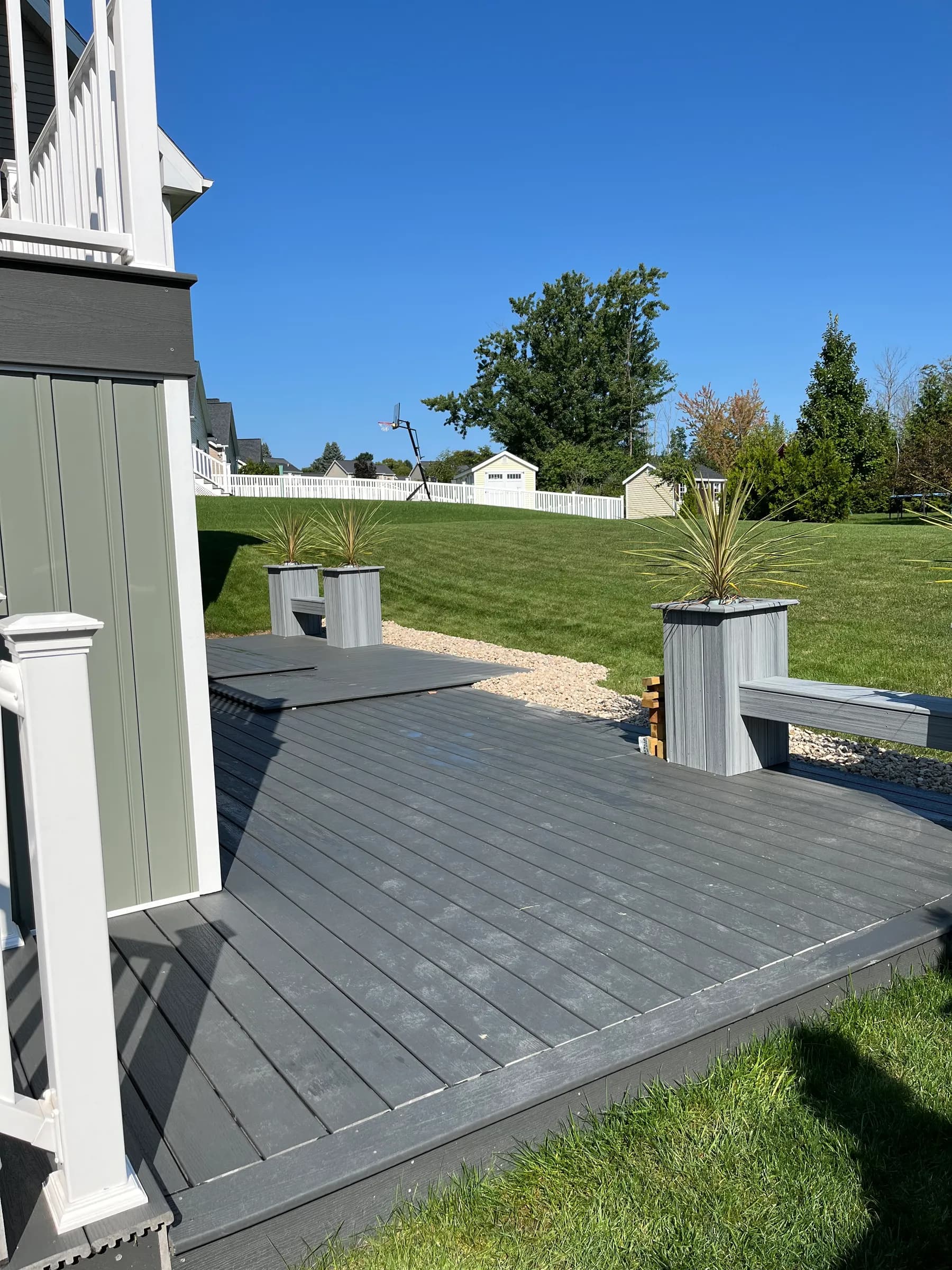 Gray composite deck with decorative white post caps
