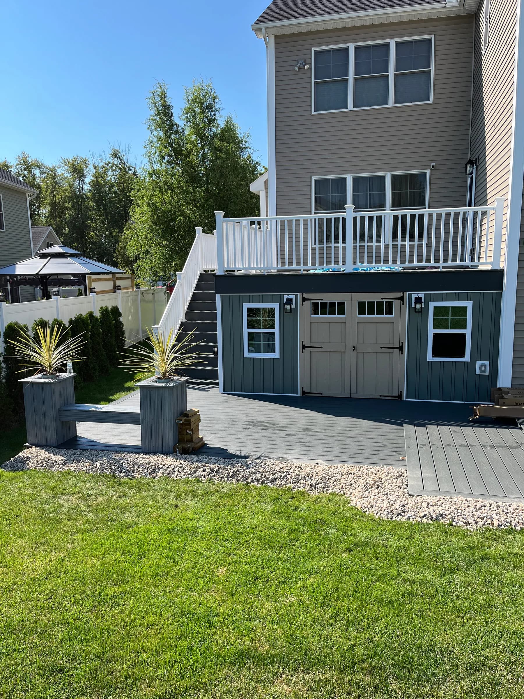 Dark green modern home with white exterior staircase