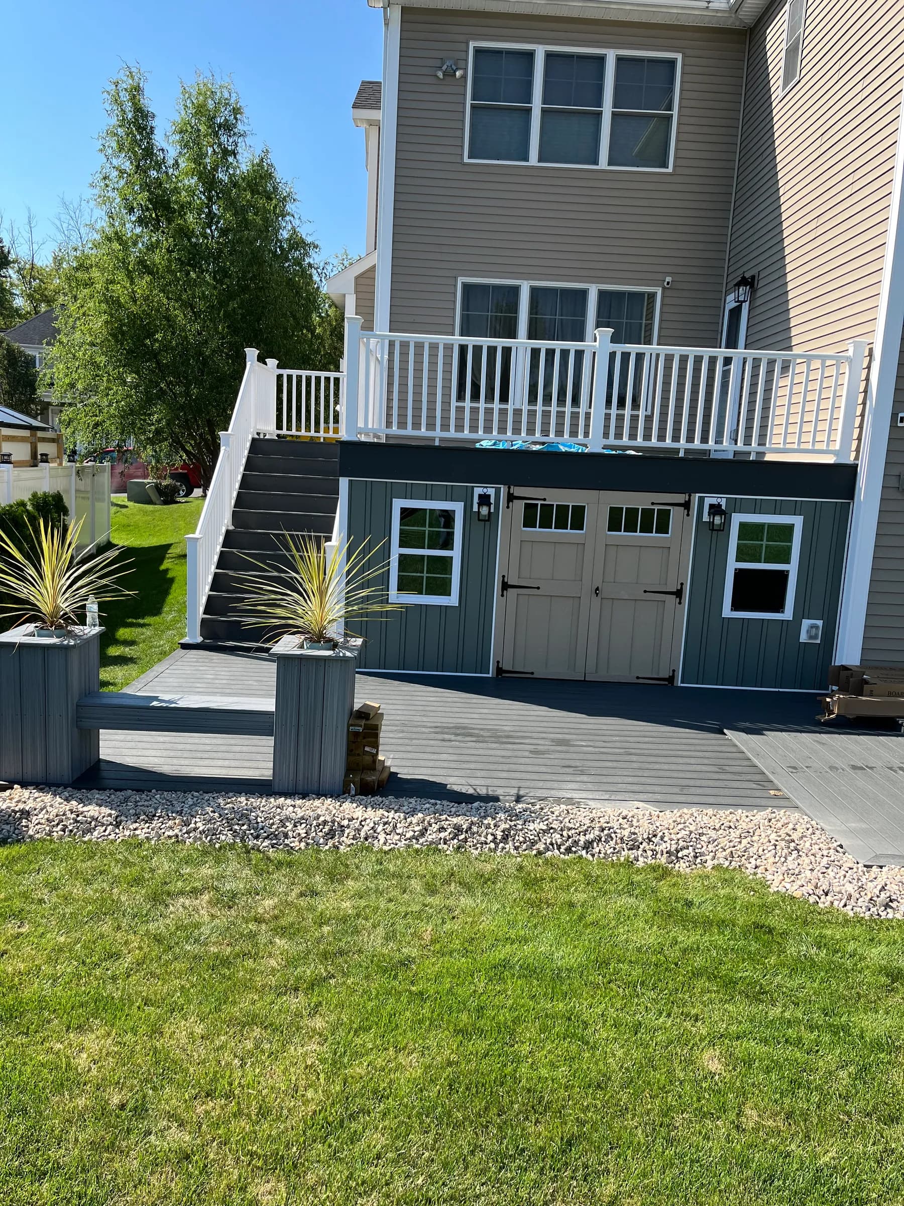 Elevated deck with white aluminum stair rails