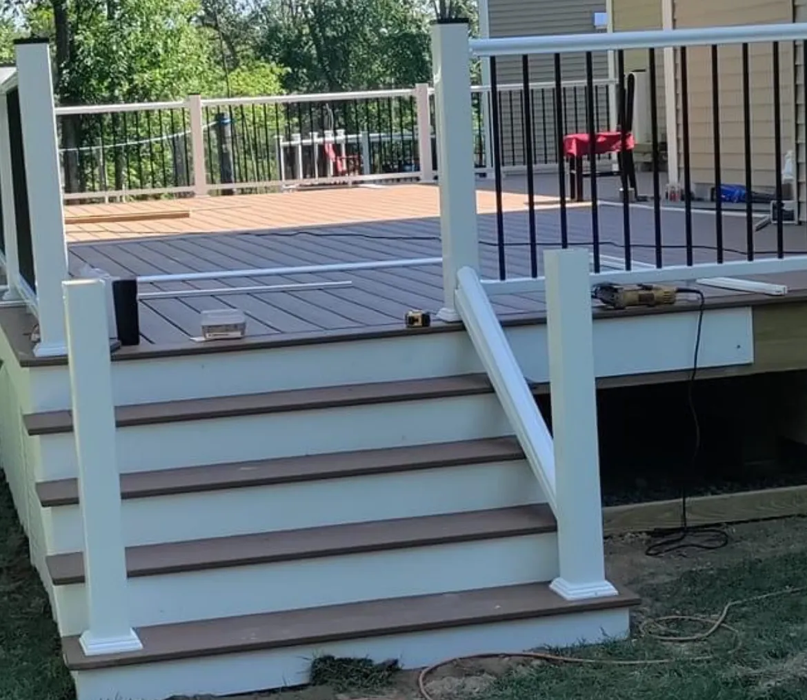 Composite deck with brown stair treads and black railings