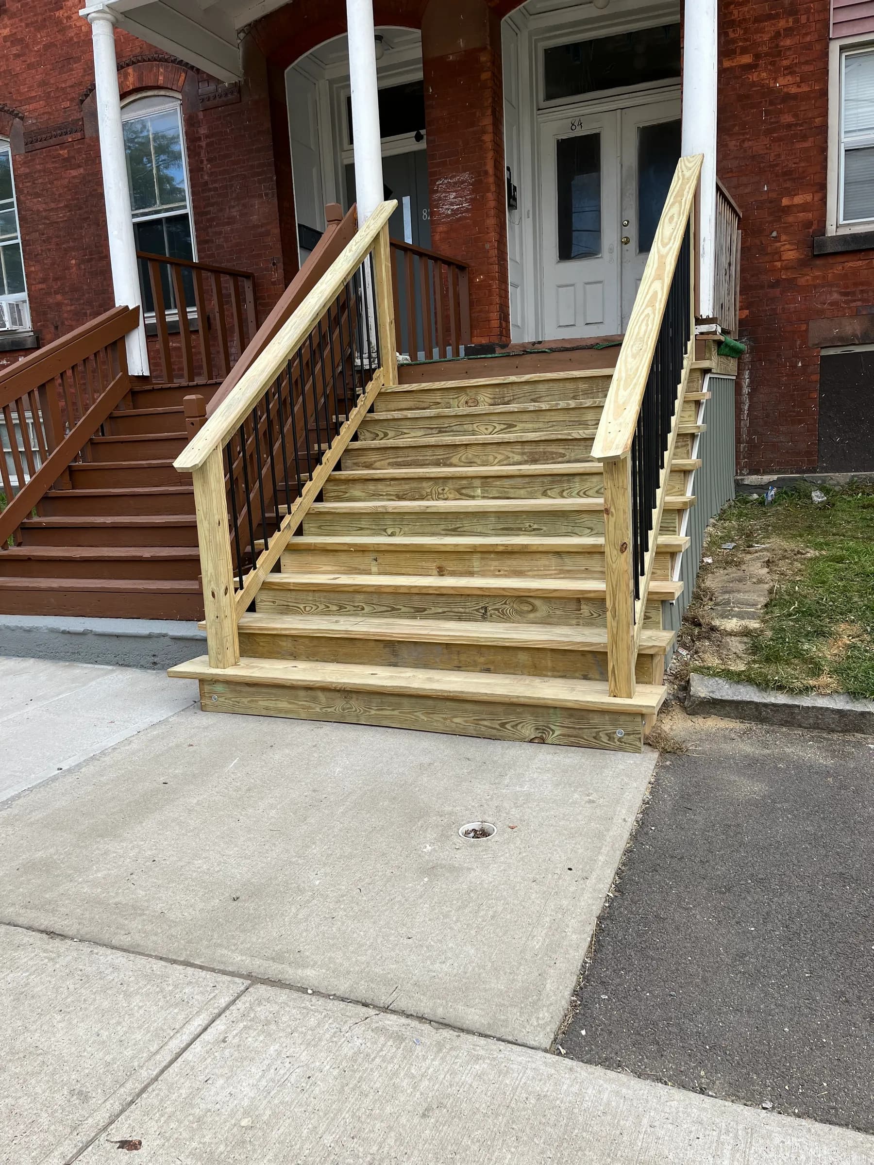 Wood deck framing at back of brown porch