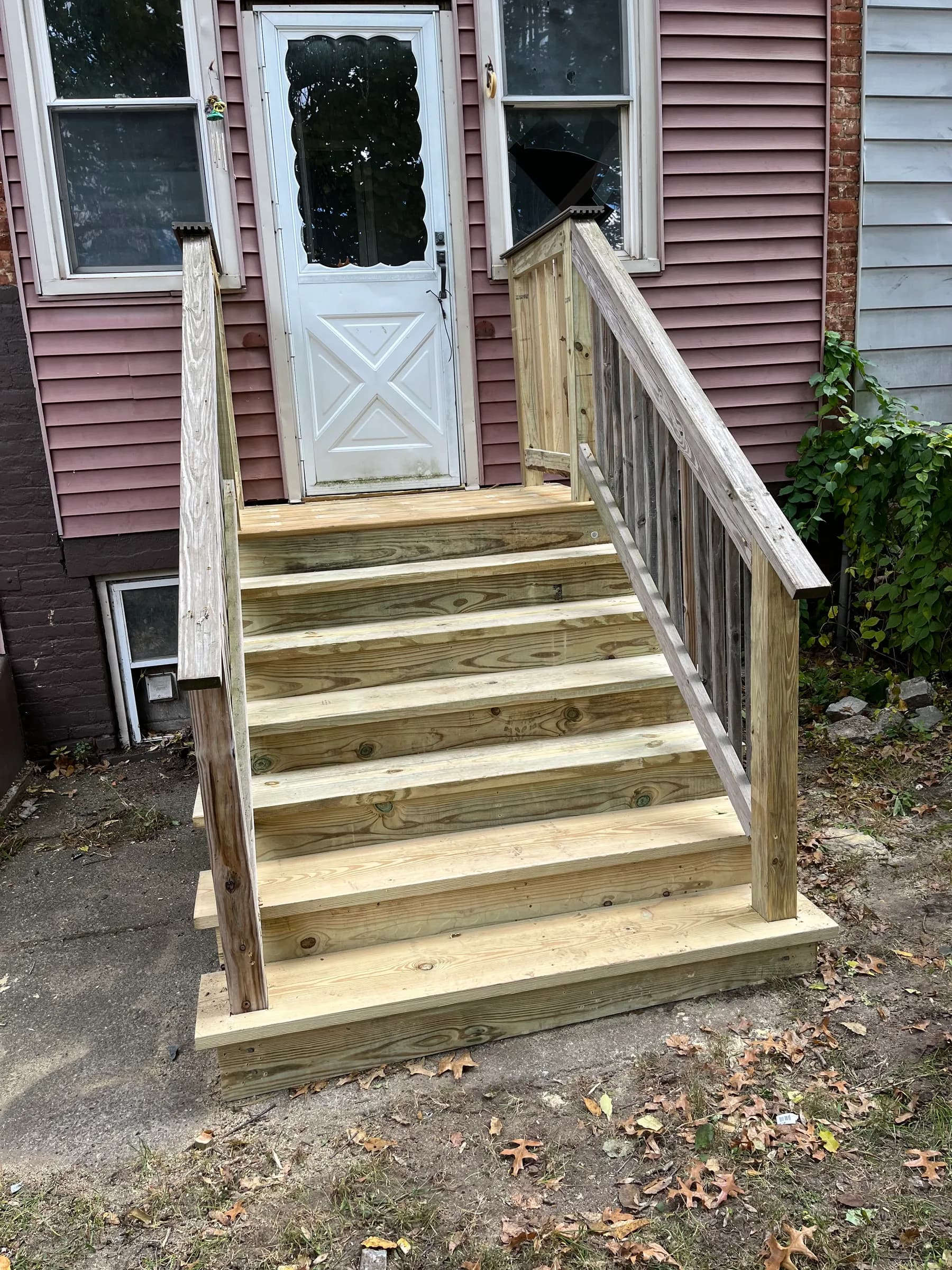 Wood porch entry stairs and railing