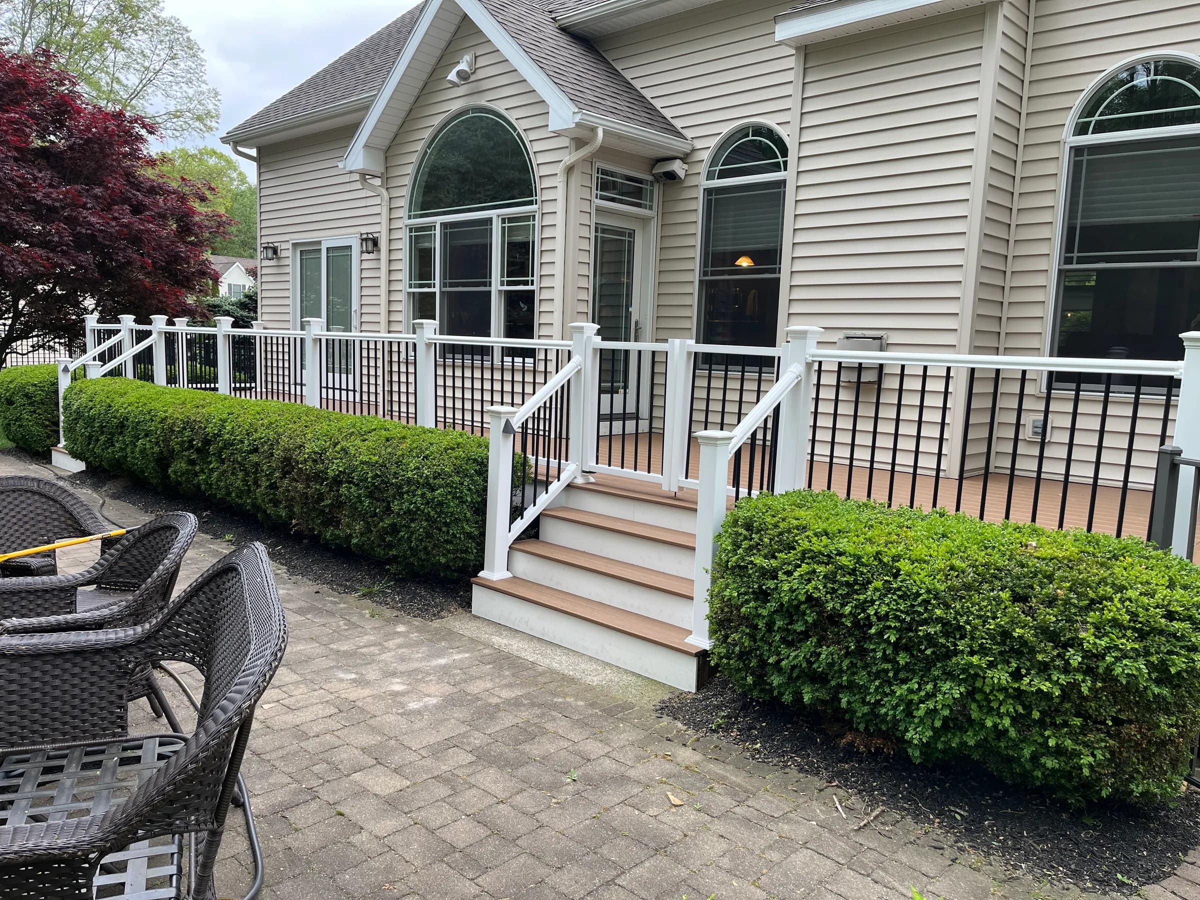 Back deck with white railings and patio furniture