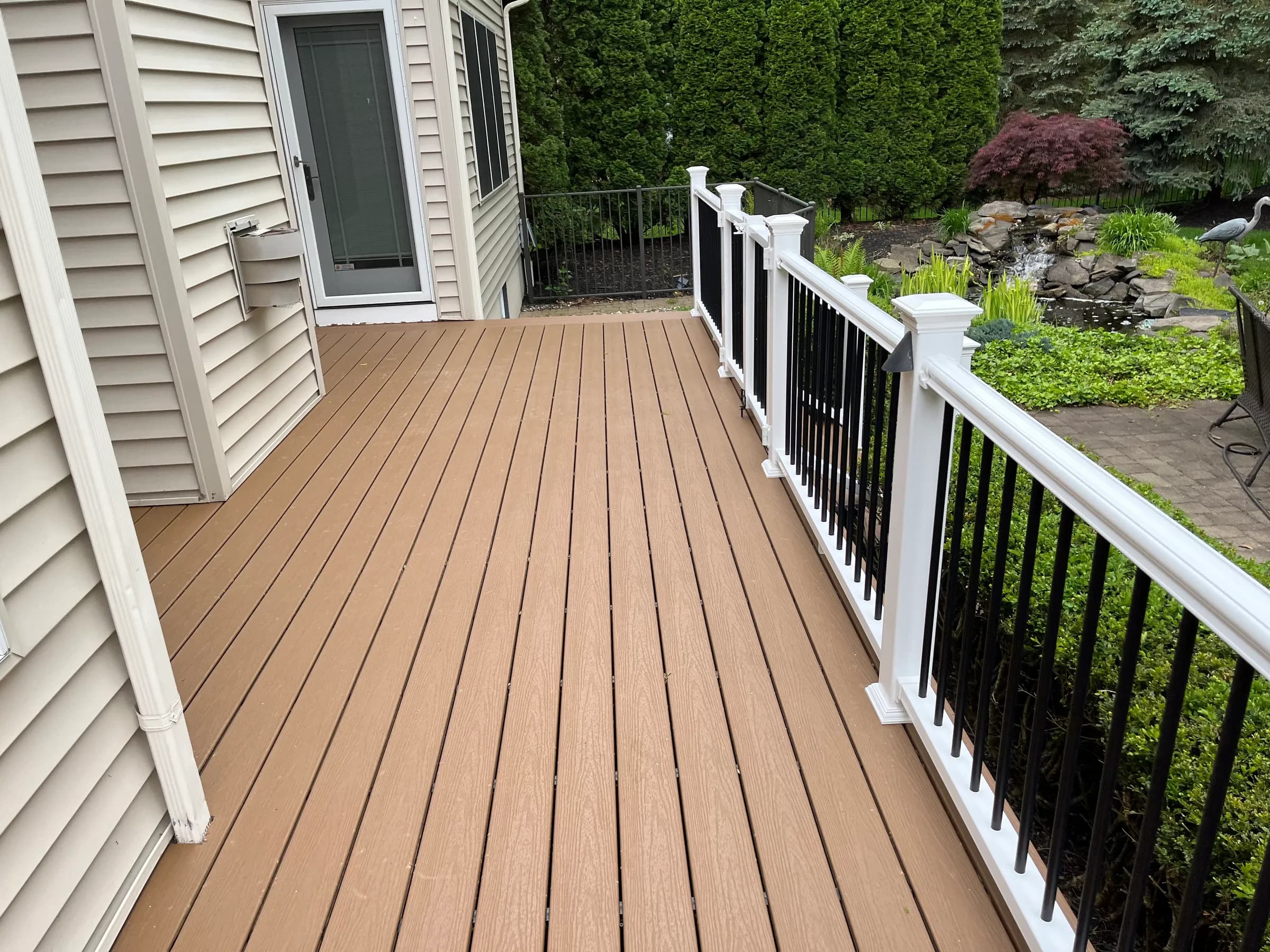 Tan deck with stairs down to patio