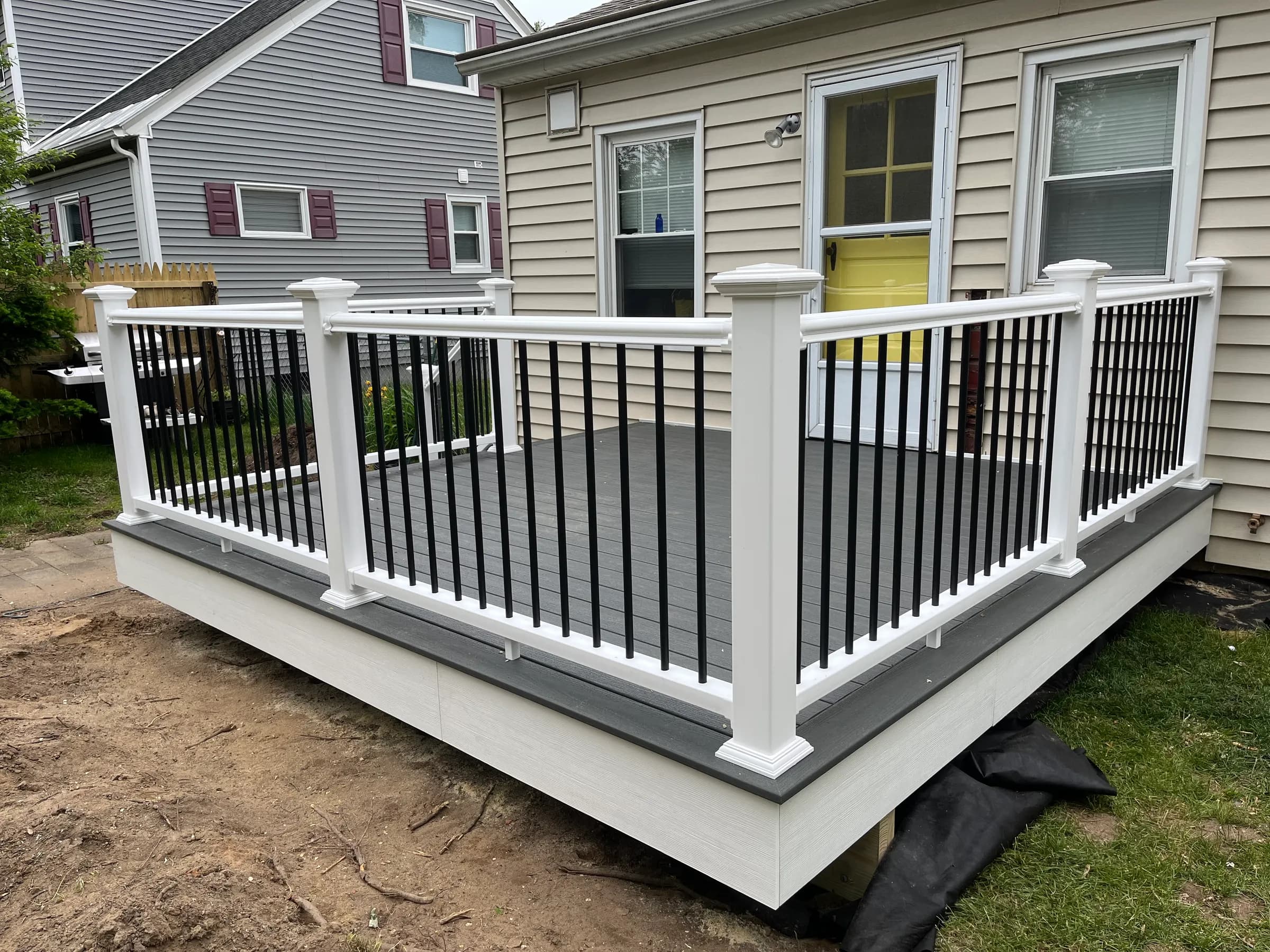 Angled view of gray deck with white railings