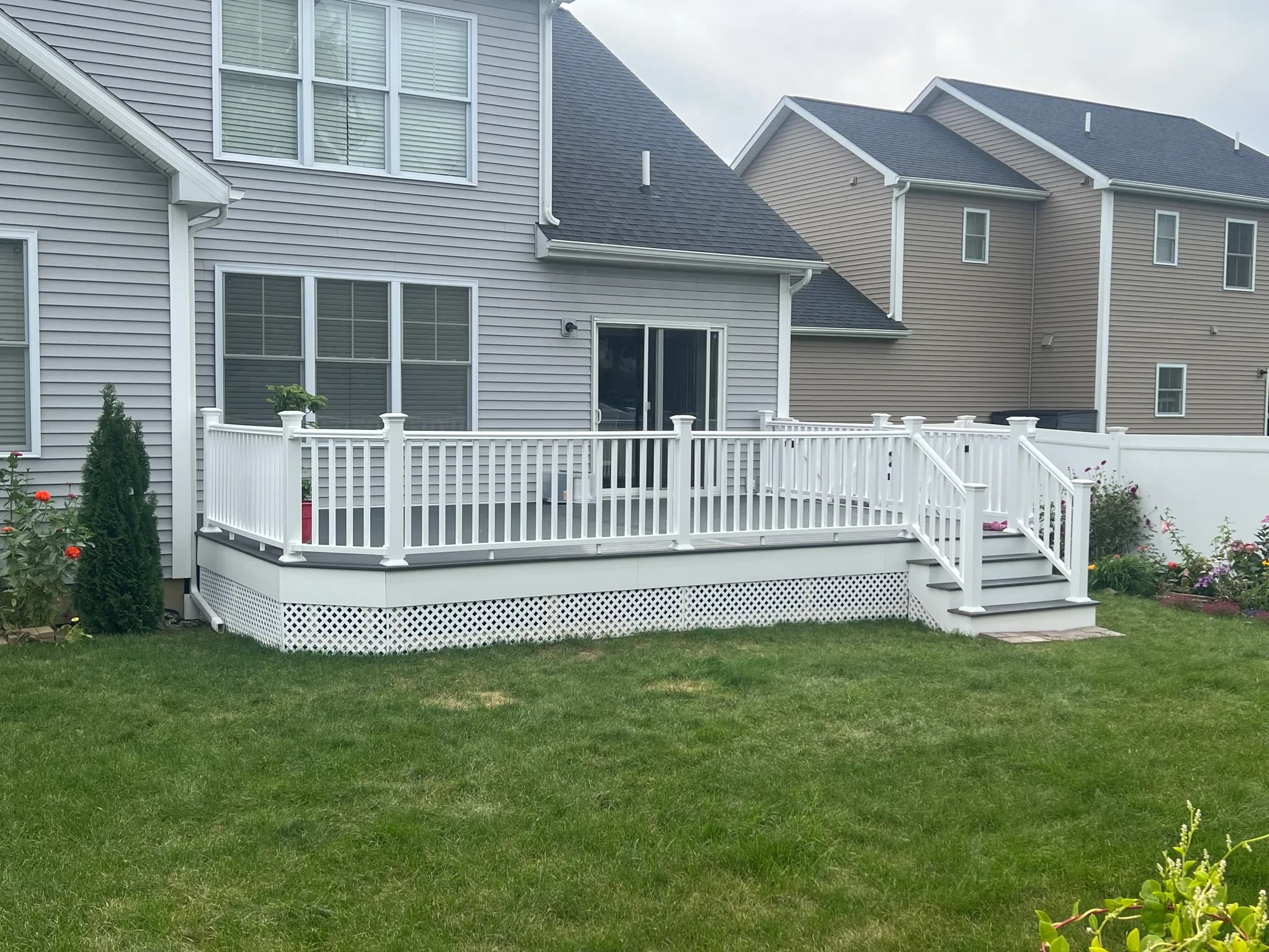 Small ground-level white railing deck