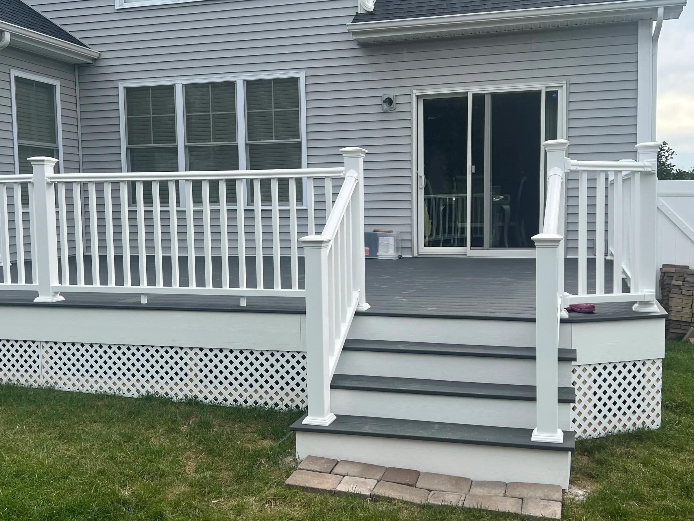 White railings with gray composite stairs at entrance