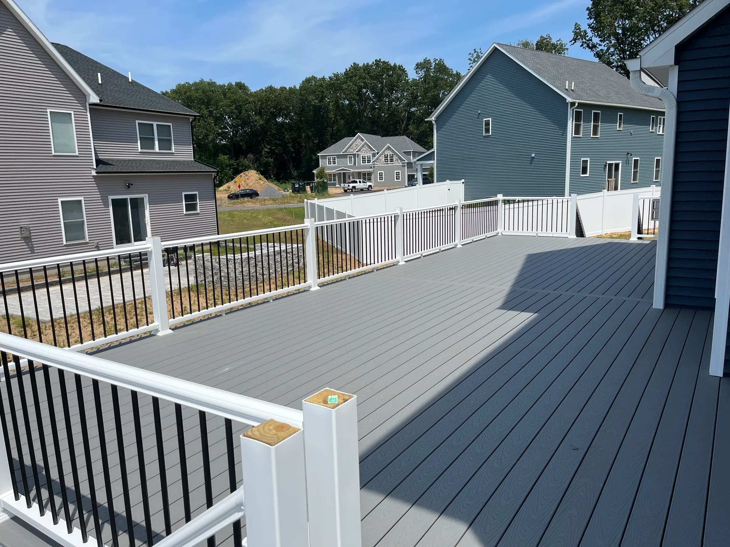 Elevated deck with composite floor on blue home