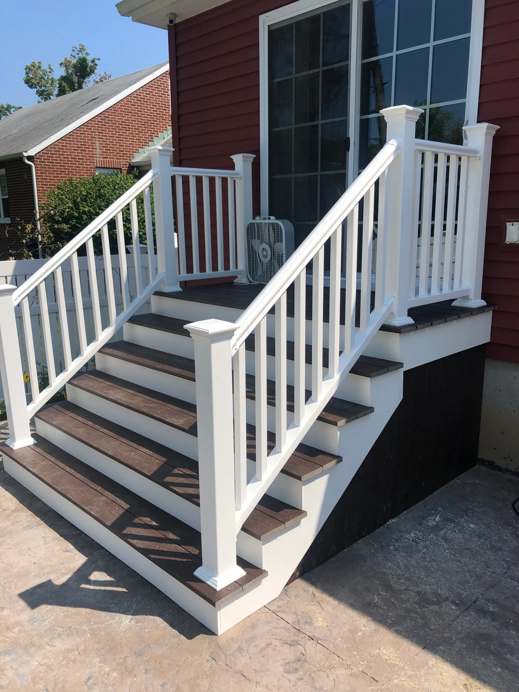 White vinyl stairs on red brick home