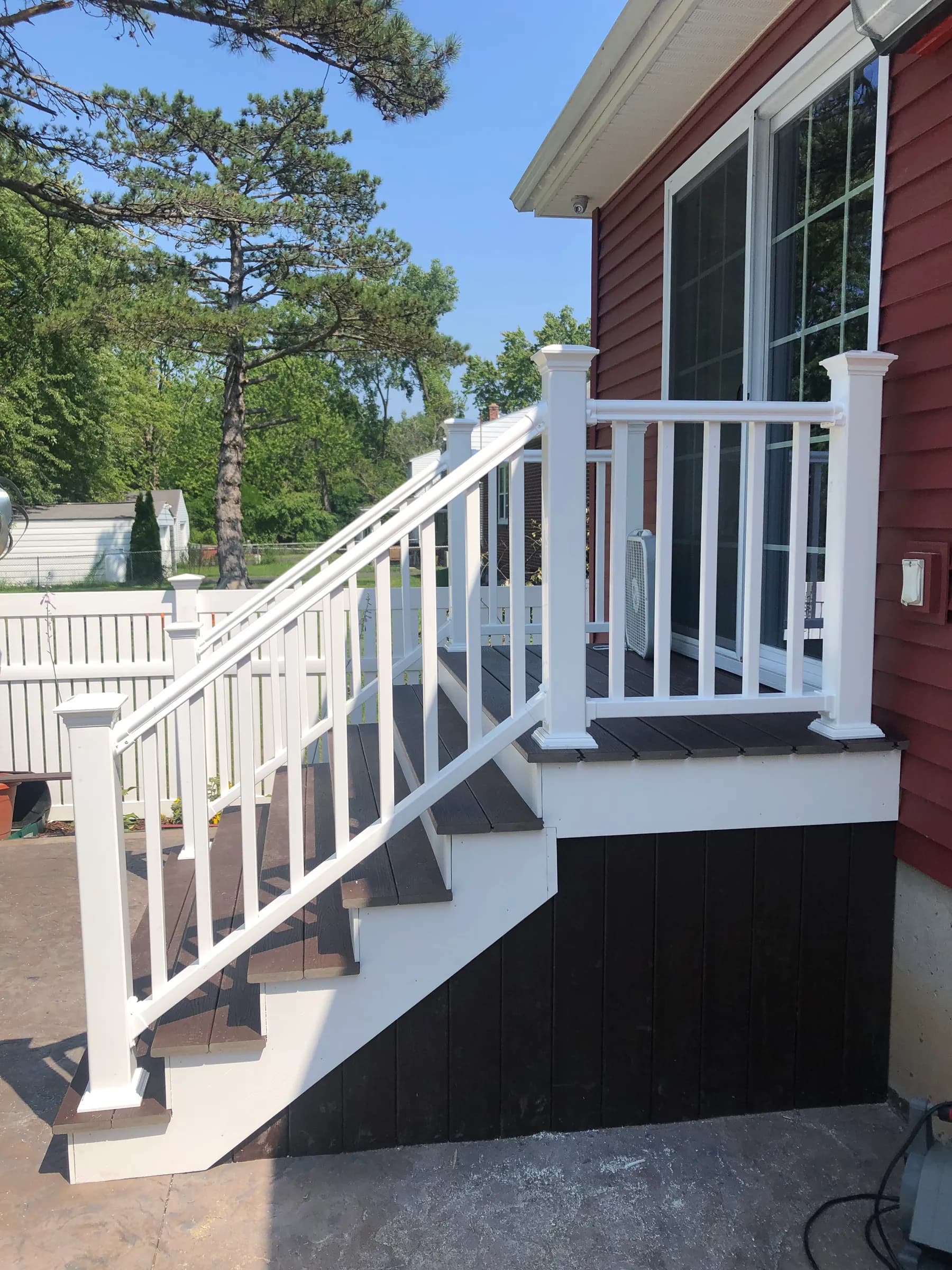 Front view of white vinyl stairs and railings