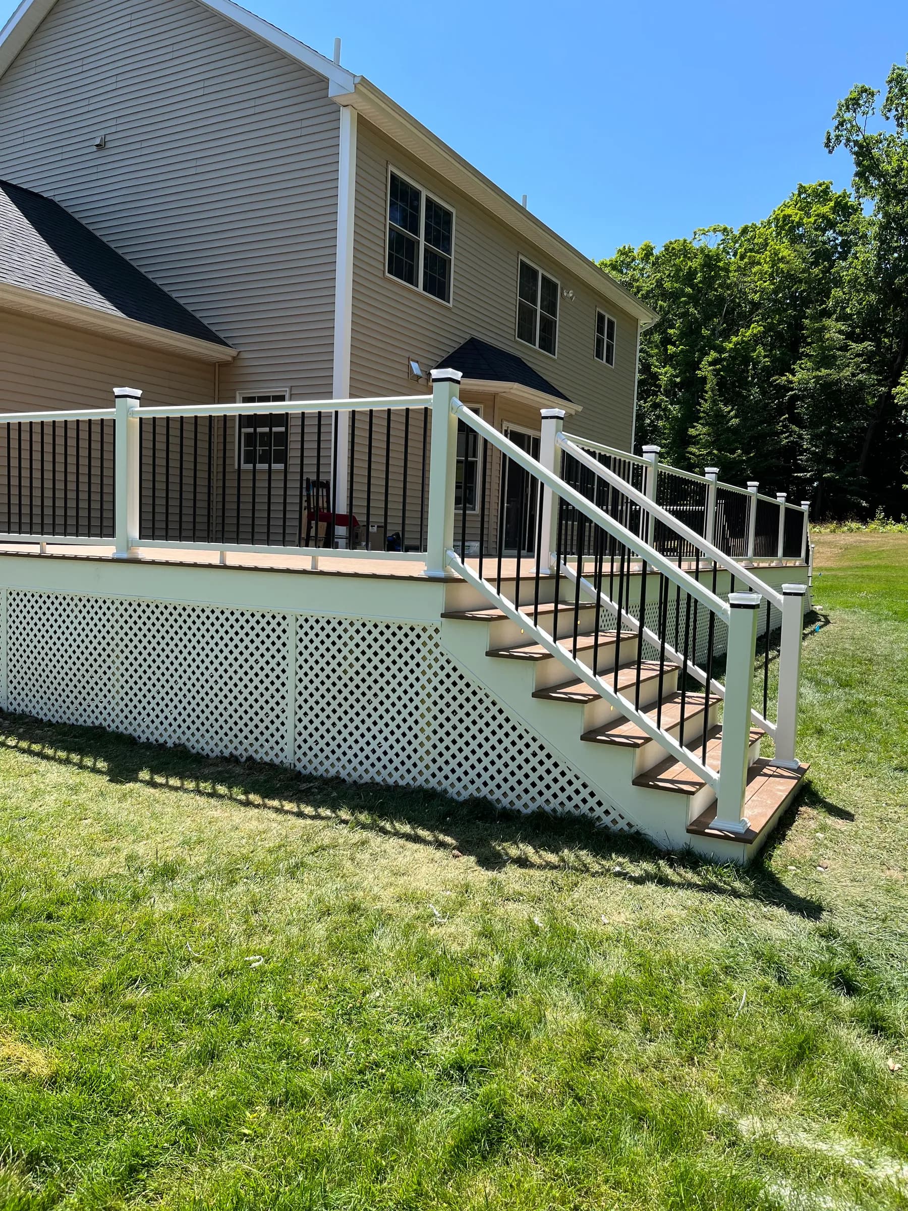 Elevated deck with pergola and white lattice skirt