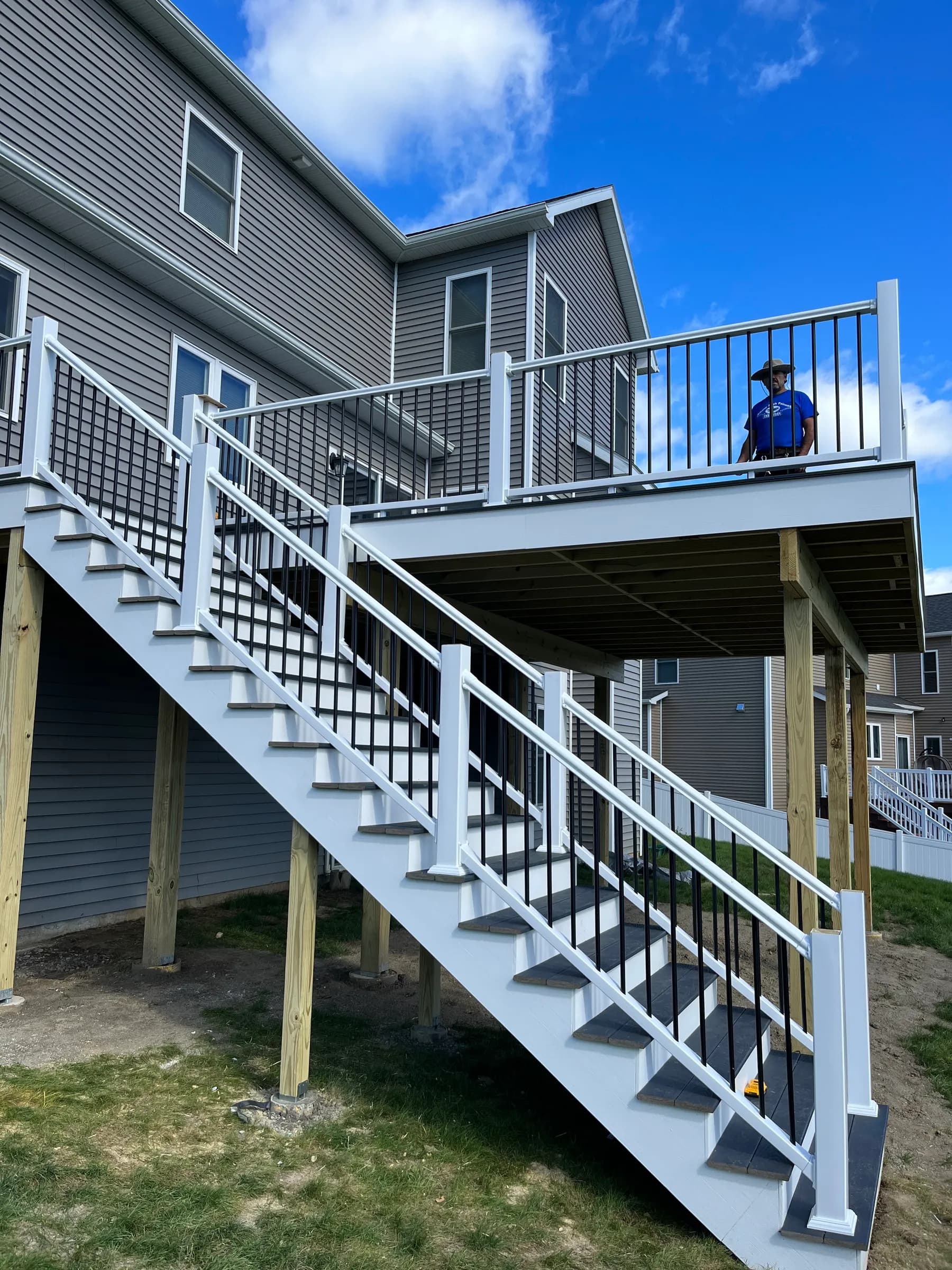 Elevated deck with blue umbrella and white cable rails