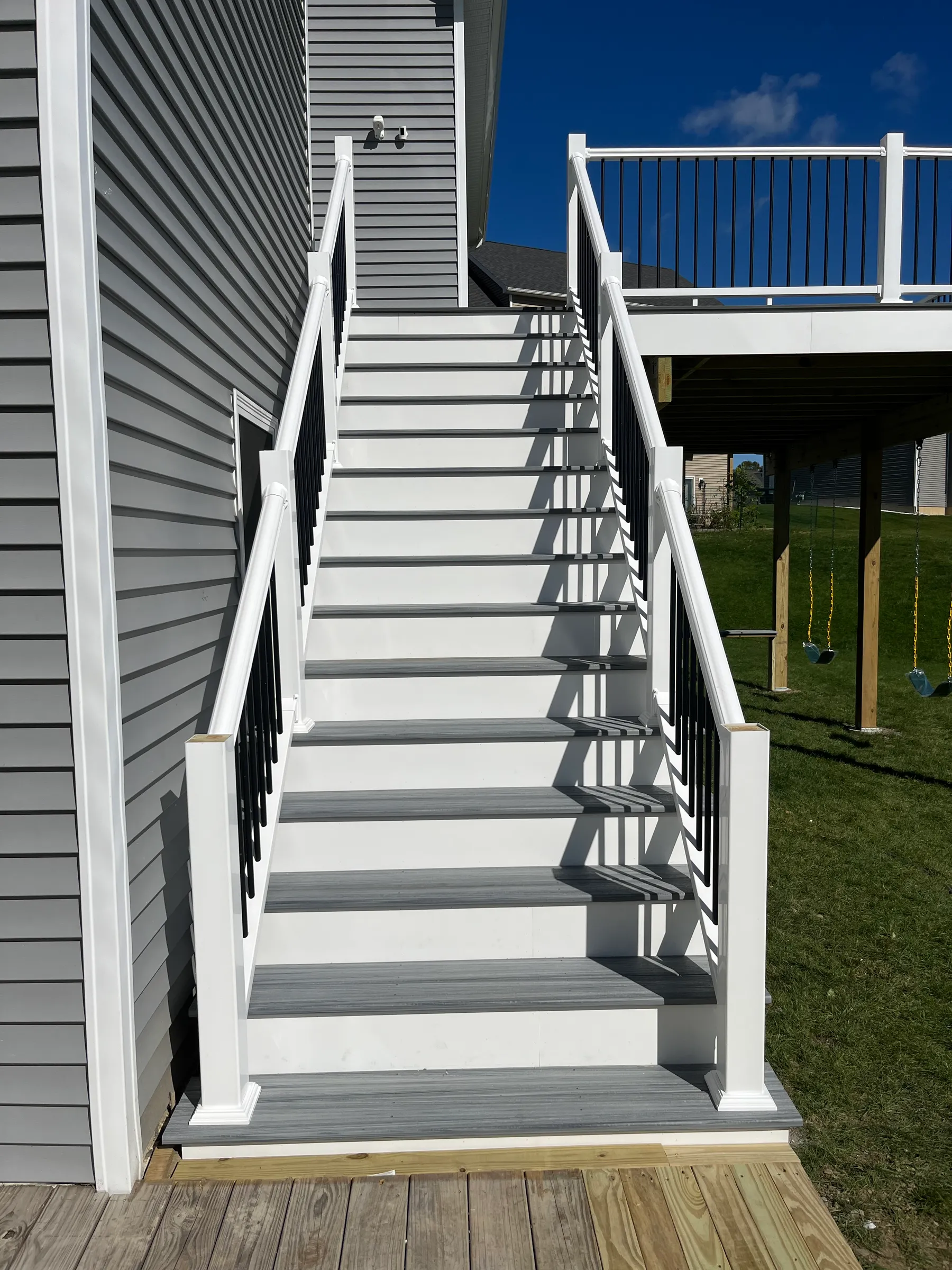 Pergola mounted on gray composite deck railing